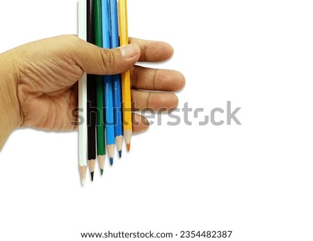 A mix colored pencils in hand isolated on white background with clipping path, back to school concept.