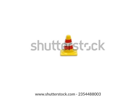 A toy traffic cone isolated on white background, abstract traffic and warning concept.