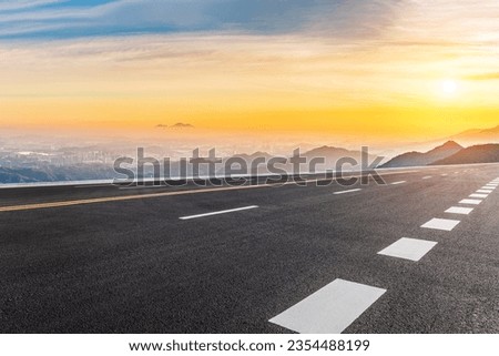 Asphalt highway road and mountain with skyline scenery at sunrise Royalty-Free Stock Photo #2354488199