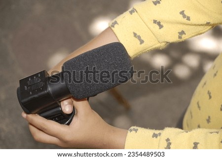 boy from southern mexico holding video camera and microphone
