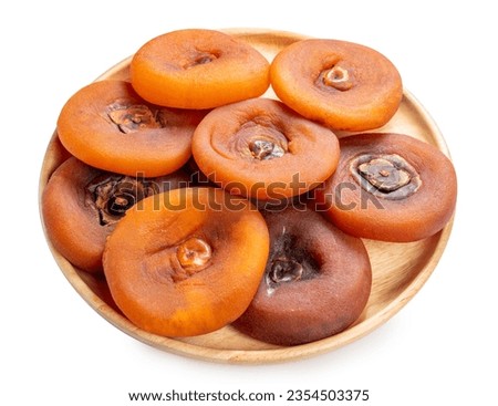 Dried persimmon in wooden plate on white background, Dried persimmon on a wooden plate isolate on white with clipping path.

