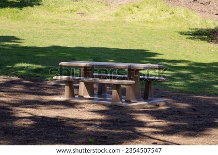 A concrete picnic table on a shaded area at Presidio Park in San Diego California USA.