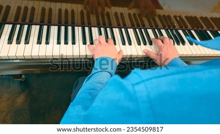 Close up Talent and virtuosity back view of man pianist hands on grand piano keyboard