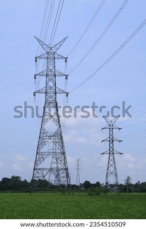 the pylon outline, Very High Voltage Power Lines (Indonesia : SUTET) on blue sky Royalty-Free Stock Photo #2354510509