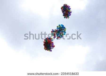 several colorful balloons flying high above the sky