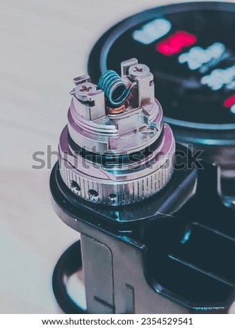 RBA (rebuildable atomizers) with burned fused clapton wire coil Royalty-Free Stock Photo #2354529541