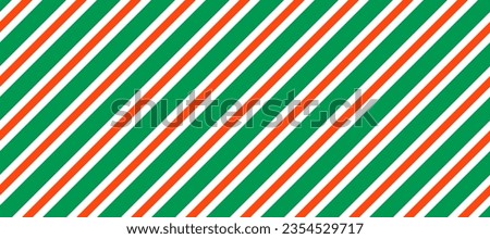 Christmas seamless pattern. Red and green diagonal stripes background. Candy cane repeating decoration wallpaper. Winter holiday lines backdrop. Xmas peppermint present wrapping print design. Vector Royalty-Free Stock Photo #2354529717