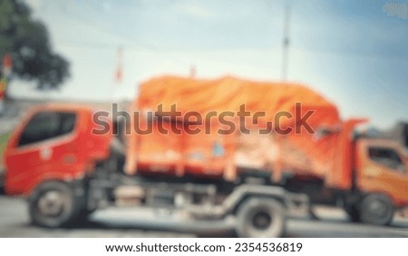 Image defocused on garbage truck during sunny day, can be used for illustration of article and website concept