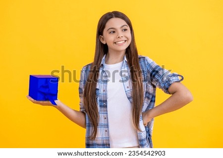 happy teen girl show present on a special occasion. teen girl with present. teen girl holding present box with excitement at birthday party. teen girl with present. childhood happiness