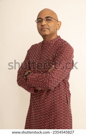 Portrait of Cheerful Happy handsome indian man looking in front of the camera. happy man wearing traditional red kurta outfit. celebrating diwali festival isolated on studio background