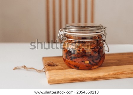 Sun-dried or dried tomato in a glass bottle, seasonal vegetables, stock up for winter