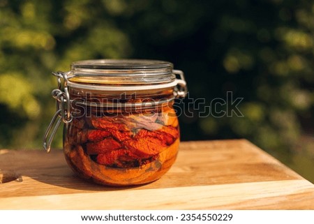 Sun-dried or dried tomato in a glass bottle, seasonal vegetables, stock up for winter