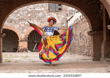 Pretty Young Woman Wearing traditional folkloric dress independence day or cinco de mayo parade or cultural Festival