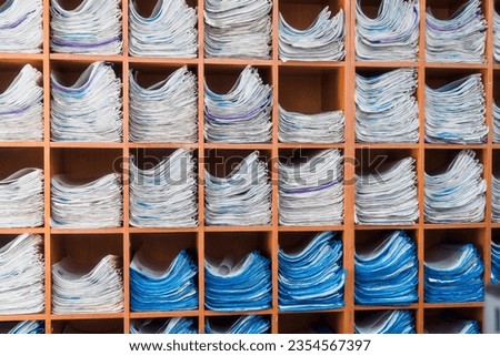 Rack with shelves. Card file with personal files. Paper documents lie on shelves in clinic.
