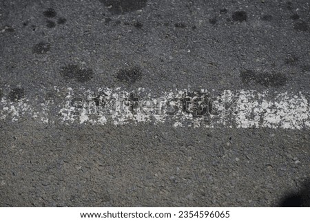 road surface texture made of asphalt with faded paint Royalty-Free Stock Photo #2354596065