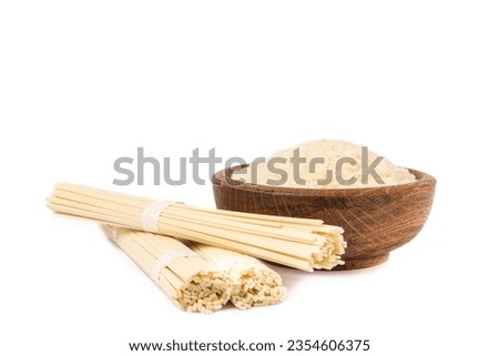 Funchoza.Dried raw rice noodles and rice isolated on white background..Noodles with rice flour. Diet food. Healthy food. Design