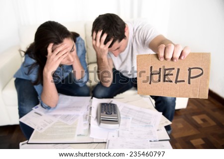 young couple worried need help in stress at home couch accounting debt bills bank papers expenses and payments feeling desperate in bad financial situation Royalty-Free Stock Photo #235460797