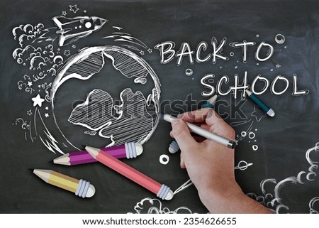 Close up of man hand drawing abstract back to school sketch with pencils and rocket on chalkboard wall background. Education and knowledge concept