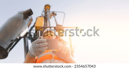Industry operator use mobile tablet for control drilling rig for exploration of minerals for oil, gas and artisan water. Royalty-Free Stock Photo #2354657043
