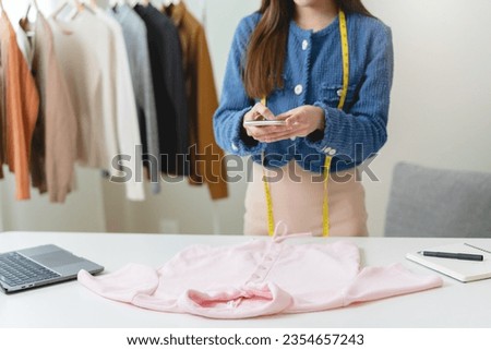 Close up person taking photo of used clothes prepare to sell in second hand online market.
