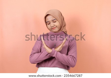 Beautiful young asian muslim woman crossing her arms say no