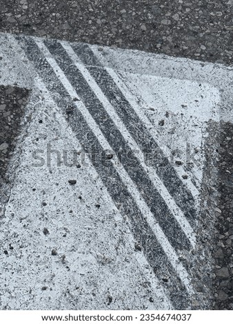 Black tire marks across a white striped crosswalk