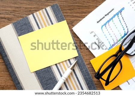 Top view of sticky note on wooden table background. Flat, creative office. Business education concept with copy space.