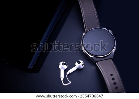 Smart watch, dark themed smartwatch shot on black background. Selective focus, noise effect.