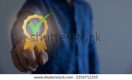 Businessman touching virtual screen icon of the best quality assurance. The check mark symbol represents the standard quality control. ISO certification international standards and quality assurance.