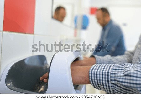 young man is drying his hands