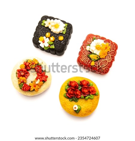 Wide variety selection Vietnamese mooncakes with trending 3D floating flower decoration isolated white background, mid-autumn festival celebration. Bakery dessert from bean, nut, rice, black sesame