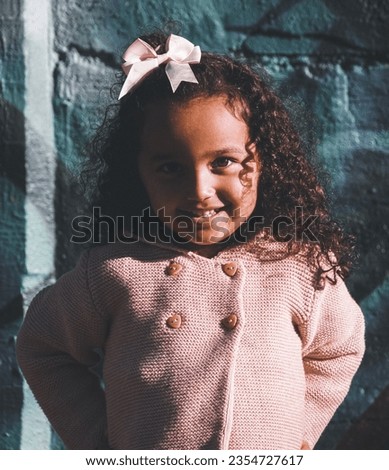 Portrait of a child against wall 