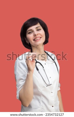 Woman doctor brunette with short haircut on red background. Royalty-Free Stock Photo #2354732127