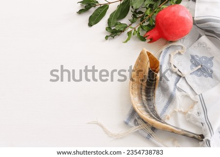 religion image of shofar (horn) and pomegranate on white prayer talit. Rosh hashanah (jewish New Year holiday), Shabbat and Yom kippur concept Royalty-Free Stock Photo #2354738783
