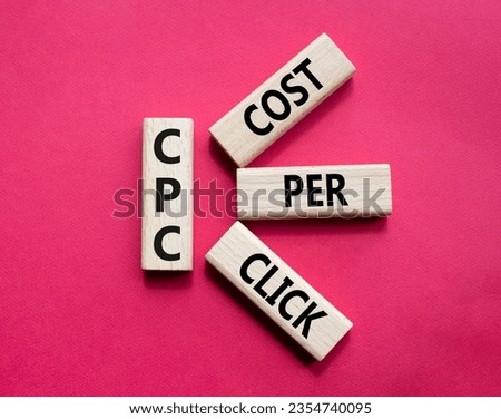 CPC - Cost Per Click symbol. Concept word AGM on wooden cubes. Beautiful red background. Business and AGM concept. Copy space.
