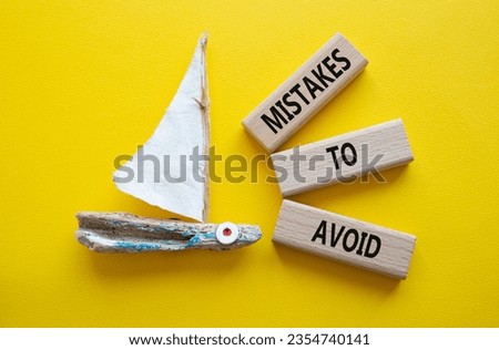 Mistakes to Avoid symbol. Wooden blocks with words Mistakes to Avoid. Beautiful yellow background with boat. Business and Mistakes to Avoid concept. Copy space.
