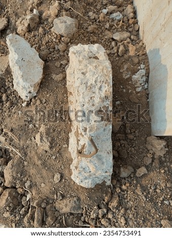 Discarded Building Rubble. Gray and white rubble at a building site. Construction scrap and waste. Small pebble rock ,dirt stone and sand background. Construction material