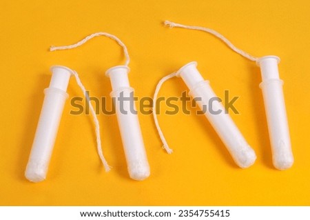 Close-up of sanitary tampons on yellow background