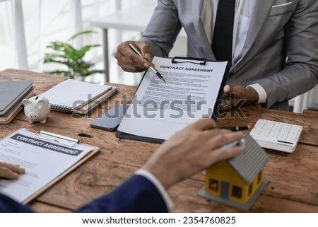 Real estate agents auction houses on projects to explain in detail to clients. Describe and present information about home purchases and mortgages. Insurance Concept Remote Picture