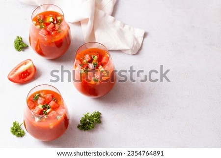 Spanish tomato and watermelon gazpacho cold soup styled and decorated in glasses Royalty-Free Stock Photo #2354764891