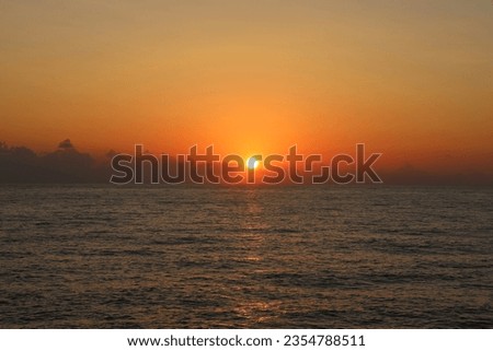 Glittering of evening sunlight reflects on sea surface. Sparkling sunlight over sea surface on waves. Sparkling water background. scenic calm ocean, sunrise sky reflecting in water. Black sea coast
