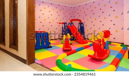 Interior of children's room, with many toys on the floor