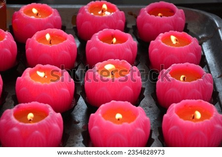 Picture of a pink candle lantern in the shape of a lotus, used on important day festivals. and used to worship the sacred in order to have light in life