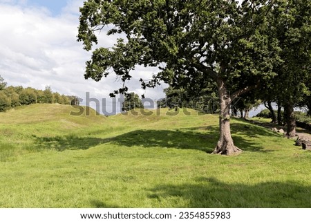 Summer time on the John Muir Way long distance walking trail at the undulating site of the Antonine wall at Rough Castle, Bonnybridge, Central Scotland. Royalty-Free Stock Photo #2354855983