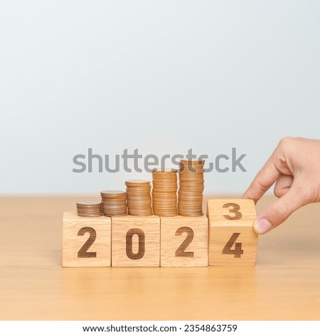 flipping 2023 to 2024 year block with Coins stack. Money, Budget, tax, investment, financial, savings and New Year Resolution concepts Royalty-Free Stock Photo #2354863759