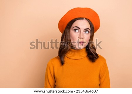 Photo of minded lady wear bright fall outfit interested look empty space banner billboard make decision isolated on beige color background