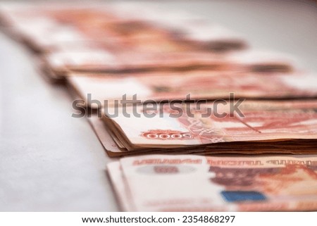 Stacks of five thousand russian rubles banknotes, selective focus. Close-up of many rows banknotes 5000 ruble notes on table, one million cash money. Exchange currency concept. Copy ad text space