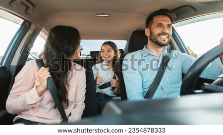 Auto purchase and rent. Happy caucasian family driving new automobile having test drive in city, enjoying road trip, panorama. Parents and child girl spending vacation traveling by car.