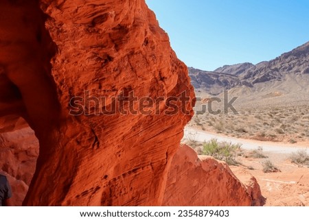 Interior view of windstone arch or fire cave in Valley of Fire State Park in Mojave desert near Las Vegas, Nevada, USA. Unique red Aztek sandstone rock formation in remote location. Good light