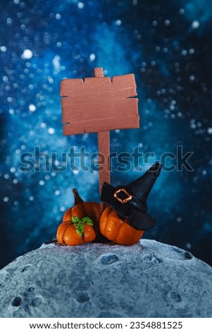 Stylized wooden signpost, witch hat and pumpkins on the moon. Mockup. Halloween background. 